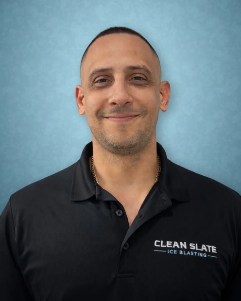 Giancarlo Garcia, co-founder of Clean Slate Ice Blasting, in a black company polo
